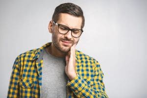 Man holding side of jaw in pain