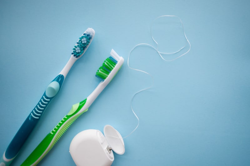 Picture of two toothbrushes and floss