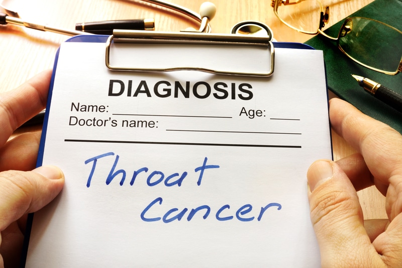 Clipboard with a paper that says "diagnosis: throat cancer".